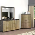 Modern bedroom scene featuring matching fluted-gold dresser and tall chest beside a window.