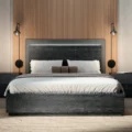Eclipse Bed - Modern dark wood bed with a sleek headboard, complemented by soft bedding and minimalist wall-mounted lamps.