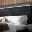 Close-up of headboard wood grain and pillow arrangement.
