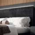 Close-up of headboard wood grain and pillow arrangement.