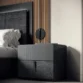 Side table beside bed showing cohesive bedroom setup.