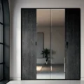 Eclipse Wardrobe with charcoal wood sides and mirrored sliding doors in a modern bedroom