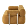 Side profile view of sofa emphasizing layered backrest and tubular metal supports.