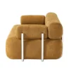 Side profile view of sofa emphasizing layered backrest and tubular metal supports.