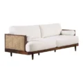 Side angle of 3-seater sofa showing cane arm detailing and plush seat cushions.
