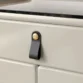Close-up of leather handle and gold accent.