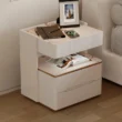Modern off-white side table with marble top, ribbed detailing, and gold trim for a refined touch.