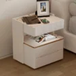 Modern off-white side table with marble top, ribbed detailing, and gold trim for a refined touch.