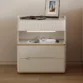 Linea Side Table - Sleek off-white design with ribbed texture, gold accents, and ample storage.