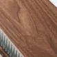 Close-up of walnut tabletop grain patterns, smooth finish, and natural color variations in wood.
