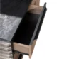 Open drawer beneath slate desktop showing smooth black interior storage space.