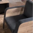 Oak Sofa single-seater close-up showing curved wood side panels and black seat upholstery