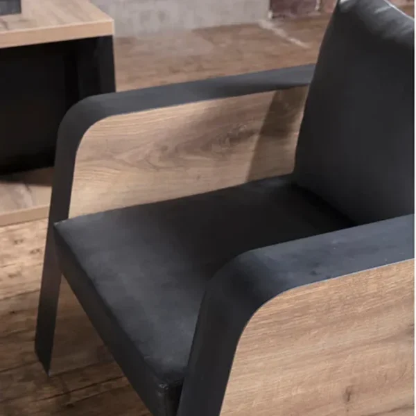 Oak-Sofa-one-seater-2-600x600 Oak Sofa single-seater close-up showing curved wood side panels and black seat upholstery