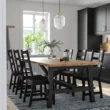 Modern 6-seater wooden dining set in Pakistan with black dining chairs and natural wood table, perfect for contemporary dining rooms and stylish home interiors