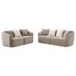 Pair of soft beige loveseats with contrasting light cushions displayed on white background.
