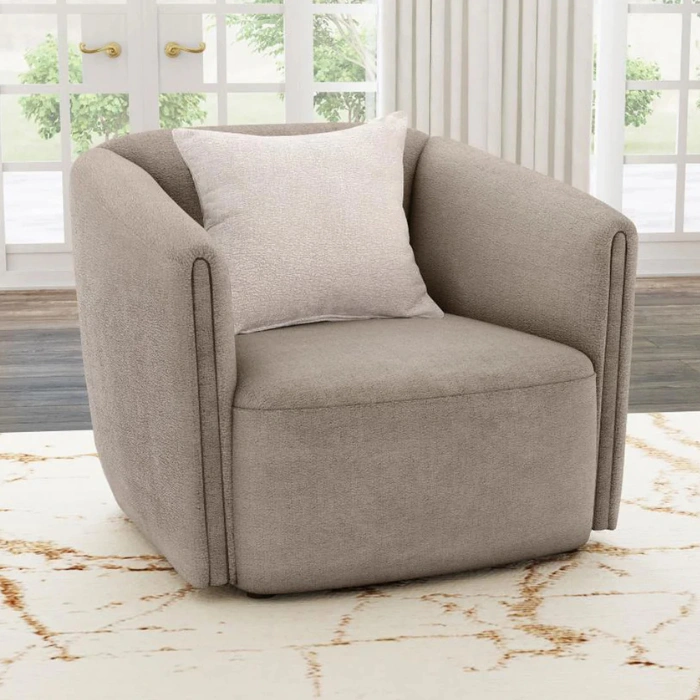 Taupe fabric armchair with curved barrel arms and a single light cushion placed on a patterned rug.