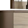 Detail of top corner showing taupe side panel and ribbed cream drawer texture near mirror.