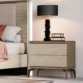 Verona Side Table with ribbed cream drawers, slim metal legs and dark top beside bed with lamp
