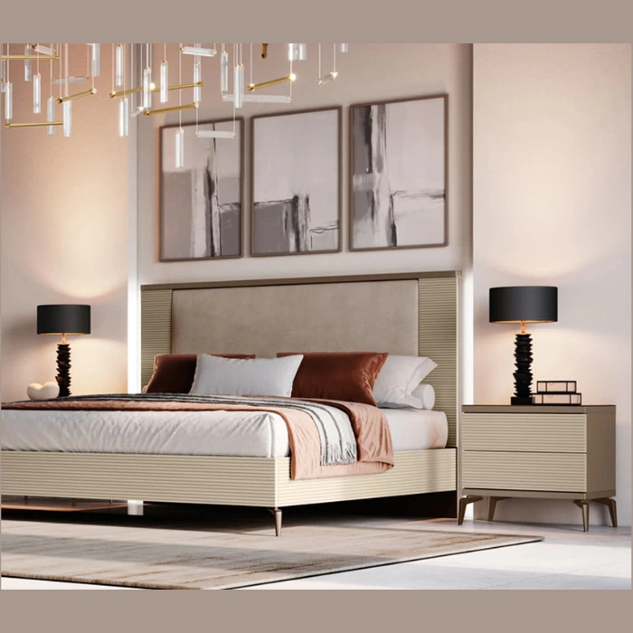 Bedroom scene with ribbed-cream bedside cabinet on slim legs, matching bed, lamps, and framed art.