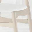 close view of cane dining chair showing faux leather seat