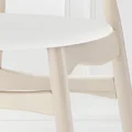 Close-up of Willow Chair seat, smooth white round seat, solid wood legs and rounded stretchers showing sturdy wooden dining chair build.