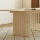 close view of dining table showing side base details.