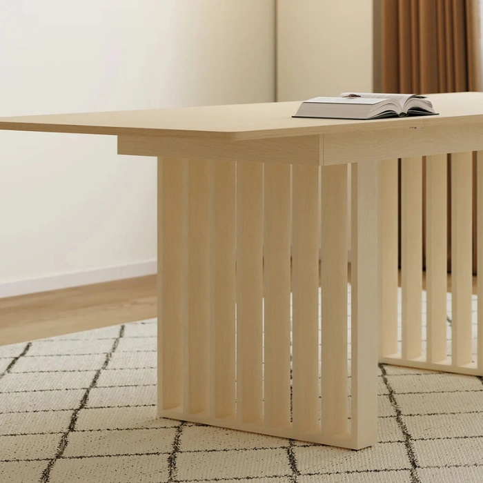 Close-up of dining table slatted pedestal base in light wood.