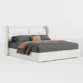 angled view of white upholstered bed in a white background.