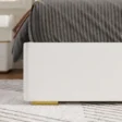 close view of bed showing base of upholstered bed