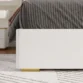 close view of bed showing base of upholstered bed