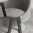Close view of grey chair showing side arms