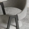 Close view of grey chair showing side arms