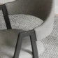 Close view of grey chair showing side arms