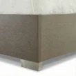 Wooden bed showing strong base edge and metal legs.