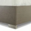 Wooden bed showing strong base edge and metal legs.