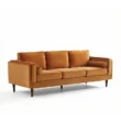 angled view of 3 seater orange sofa in a white background