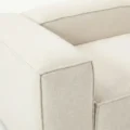 close view of armrest of white sofa