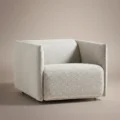 aircush offwhite upholstered armchair in studio background