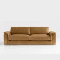 front view of bruno curve sofa in brown upholstery