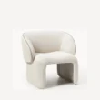 angled view of white boucle armchair