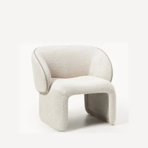 angled view of white boucle armchair