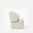 side profile view of white boucle armchair