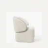 side profile view of white boucle armchair