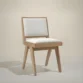 solid oak wood chair with off white upholstery in studio background