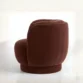 side profile view of umber armchair in white background