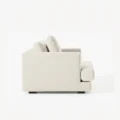 side profile view of white fabric armchair