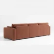 reaer view of brick red 3 seter sofa.
