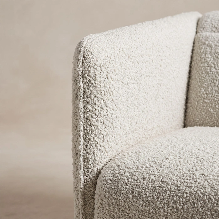 aircush-armchair-off-white-arm-upholstery-closeup-detail-view. Close-up of the textured off-white upholstery and padded arm edge