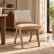 Noble upholstered dining chair styled in a warm contemporary dining interior