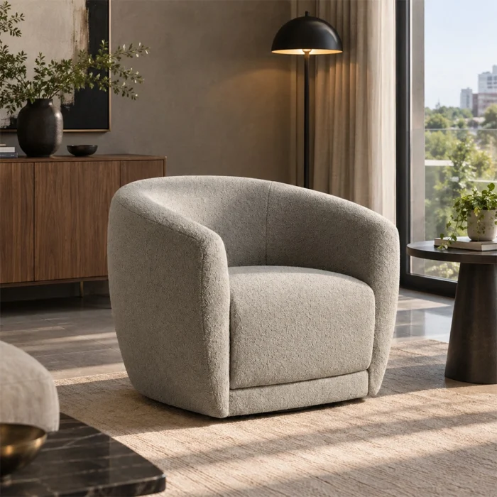 CreamCove curved armchair in warm ivory upholstery styled in a modern living room